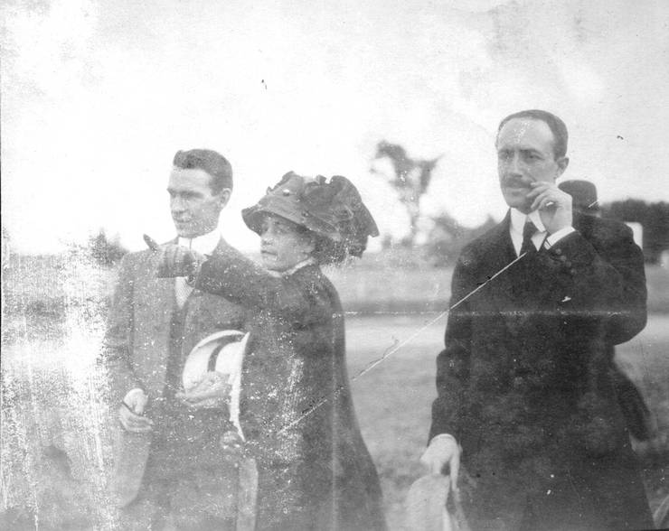 Count Jacques de Lesseps (right), two men and a woman on a field.