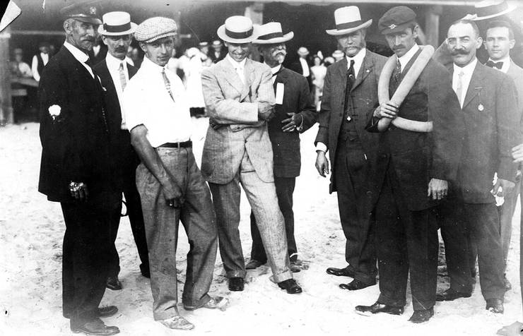 Walter Brookins (3rd from left), Roy Knabenshue (4th from left), and Glenn Curtiss (wearing inner tube life preserver) with unidentified men at Atlantic City, New Jersey.