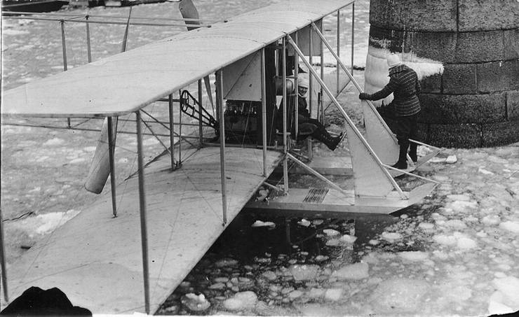 Frank Coffyn standing on hydroaeroplane pontoon with passenger aboard, New York, 1912.