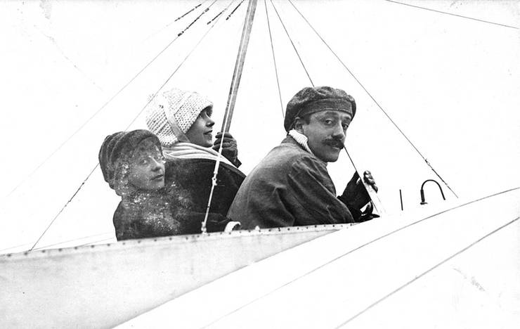 Postcard of Count Jacques de Lesseps and women passengers aboard a Bleriot aircraft.