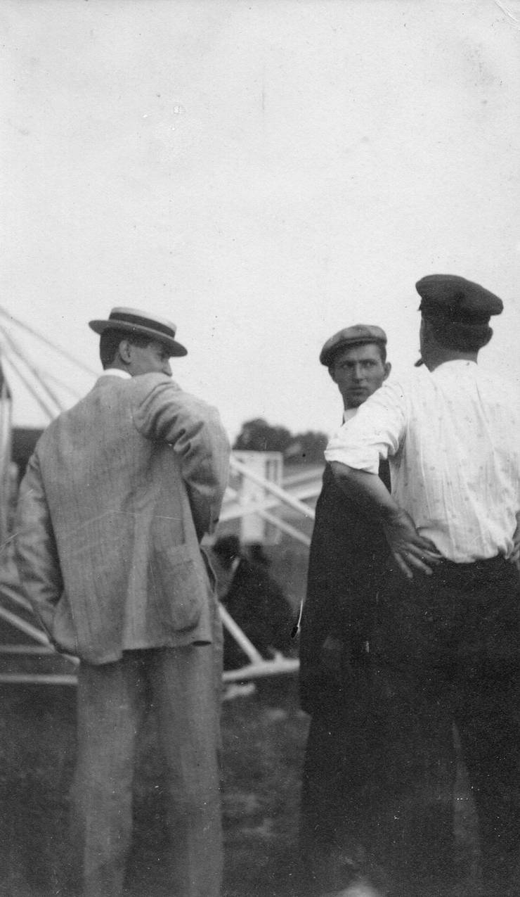 Walter Brookins (center) and unidentified men in front of Wright transitional aircraft.