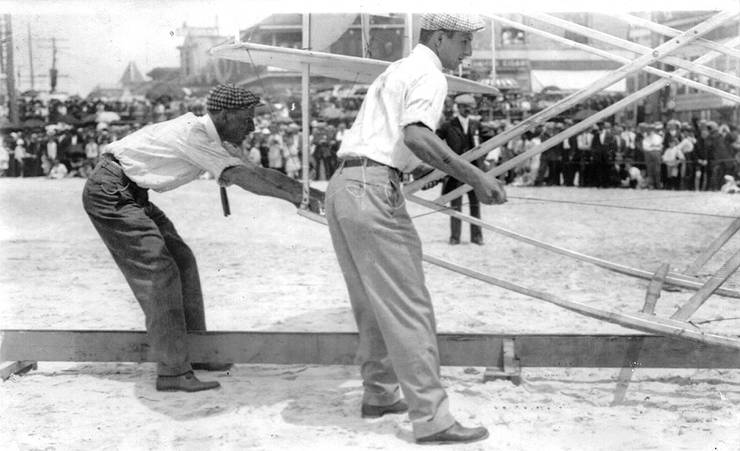 Frank Coffyn and Walter Brookins setting Wright transitional aircraft on launching rail, Atlantic City, New Jersey.