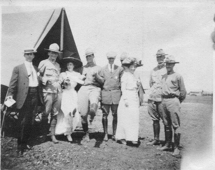 Frank Coffyn, his wife, and military personnel posing in front of a tent, Fort Sam Houston, Texas.