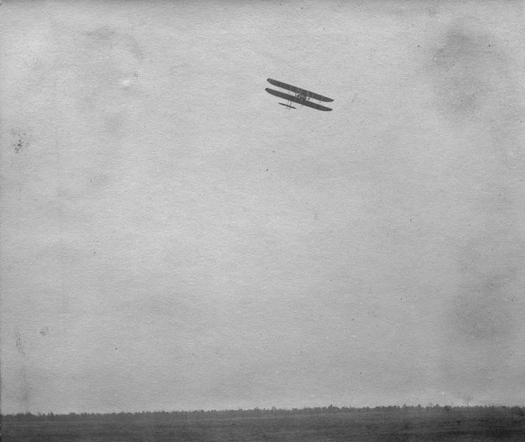 Frank Coffyn flying a Model B with a passenger.