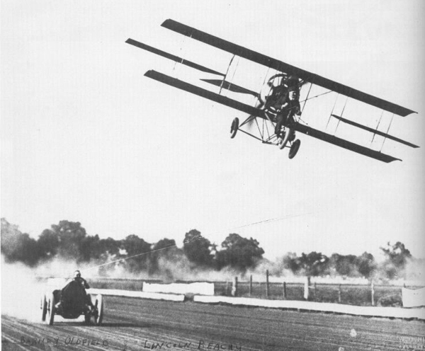 Stunt flyer Lincoln Beachey races a car
