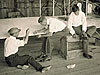 Arch Hoxsey (center) repairing the fabric to a Wright 'transitional' aircraft, Montgomery, Alabama, 1901.Image credit: Wright State University